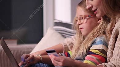 Mother and daughter shopping online together