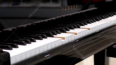 Motion of piano auto playing with blur people shopping