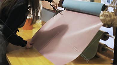 Close up of flower shop assistant cutting paper with scissors