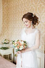 Brown-haired woman with classic wedding hair-style.
