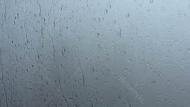 Water drips on a window glass