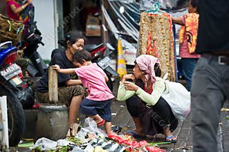 Women and child in polluted market in Bali, Indonesia.