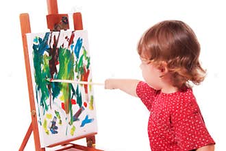 Child painting on easel