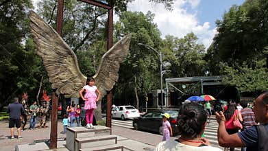 Mexico City, Mexico-CIRCA July,2014: Tourists taking pictures in wings structure in Reforma Avenue.