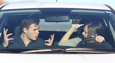 Couple arguing while she is driving a car
