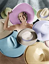 Portrait of a young woman covered with hats