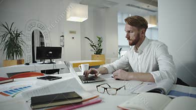 Handsome businessman working at the office and looking at photo frame