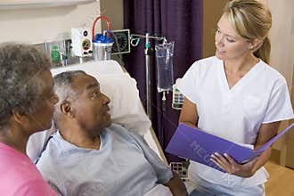 Doctor Talking To Senior Couples