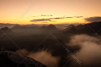 Time lapse sunset and waving fog in popular valley of Saxony Switzerland. Peaks of hills are sticking out from fog