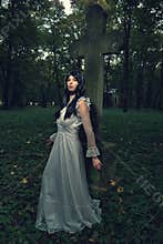 Witch from the cemetery, in front of cross