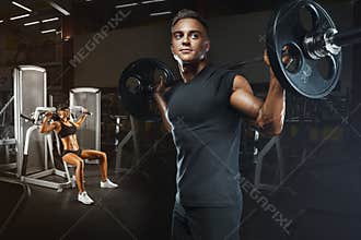 Young and fit couple in the gym doing workout