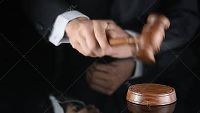 Judge. Referee hammer and a man in judicial robes