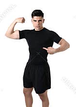 Attractive sport man pointing on his black t-shirt with copy space for adding gym fitness health club logo
