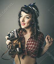 Trendy woman in 60s top with retro camera