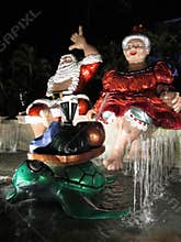 Mr. and Mrs. Claus sit on top waterfall
