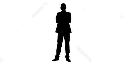 Silhouette of businessman standing with arms crossed