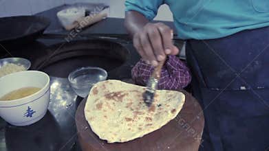 Indian chef buttering garlic naan. Indian cuisine