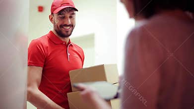 Happy man delivering parcel boxes to customer home