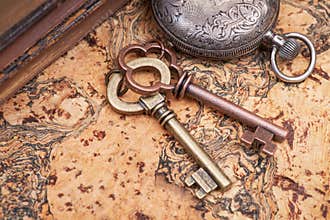 Panta rhei concept: Antique pocket watch, vintage keys and pile of old books on natural cork
