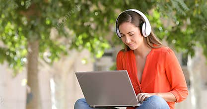 Woman e-learning with a laptop in a park