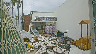 Man Walks About House with Collapsed Roof after Hurricane