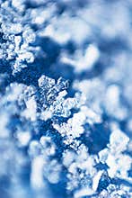 Distinct snowflake on blue velvet detail macro background