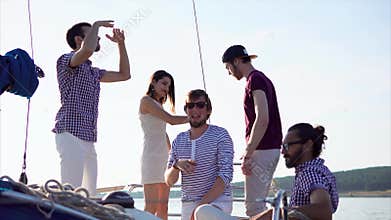 Happy friends enjoying yacht travel and having party