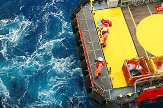 Supply boat transfer cargo to oil and gas industry and moving cargo from the boat to the platform, boat waiting transfer cargo