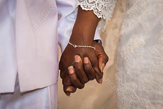 Black couple holding hands during marriage