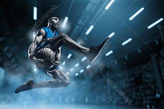 Basketball player on big professional arena during the game. Basketball player making slam dunk.