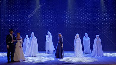 Beautiful woman sings on the stage in theatre