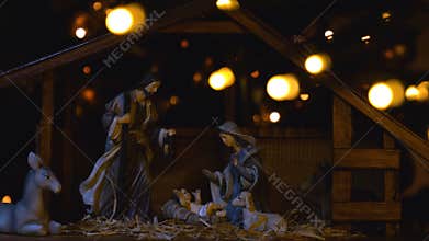 Jesus Christ Nativity scene with atmospheric lights and candles