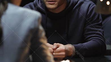 Suspect man under detective pressure denying crime commitment, false testimony