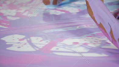 Blonde girl sitting on a large square