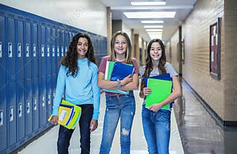 Group of Junior High school Students standing together in a school hallway