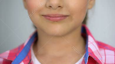 Little girl holding lollypop, dental care concept, sugar causes caries, diabetes