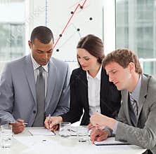 Concentrated business people studying sales report