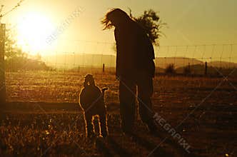 Silhouettes best friends woman dog walking golden glow sunset country
