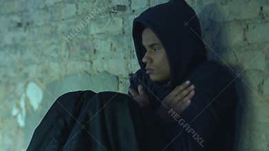 Homeless refugee freezing in cold passage, lack of money and opportunities