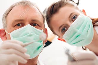 Dentist, Assistant and drill in a treatment