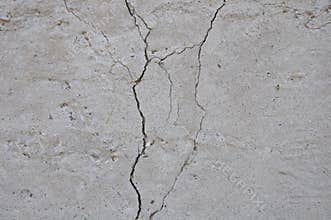 Gray concrete texture background. Damage. Cracked stone wall background