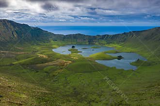 Aerial view of volcanic crater Caldeirao with a beautiful lake on the top of Corvo island. Azores islands, Portugal