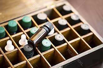 Aromatherapy essential oils in wooden box. Herbal alternative medicine with essential oils bottles in wooden box, healthy organic