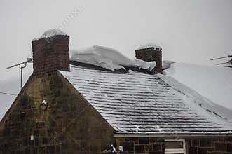 Roof exposed after snow slid off circa 1800 building.