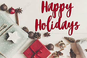 Happy holidays text, seasonal greetings card sign. christmas fla