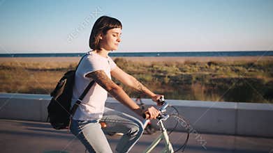 Brunette cycling in promenade