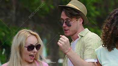 Positive woman and man showing funky dance moves at music fest, youth partying