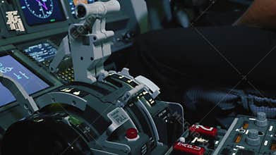 Airliner cockpit inside. Close-up of thrust lever handle for engine control.