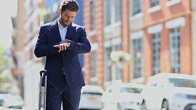 Businessman Using Mobile Phone App To Order Taxi