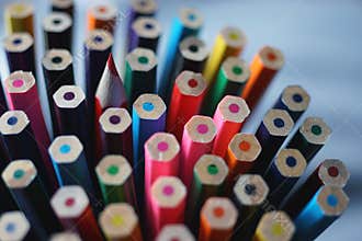 Bottom of multicolored wooden crayons and one sharp color pencil
